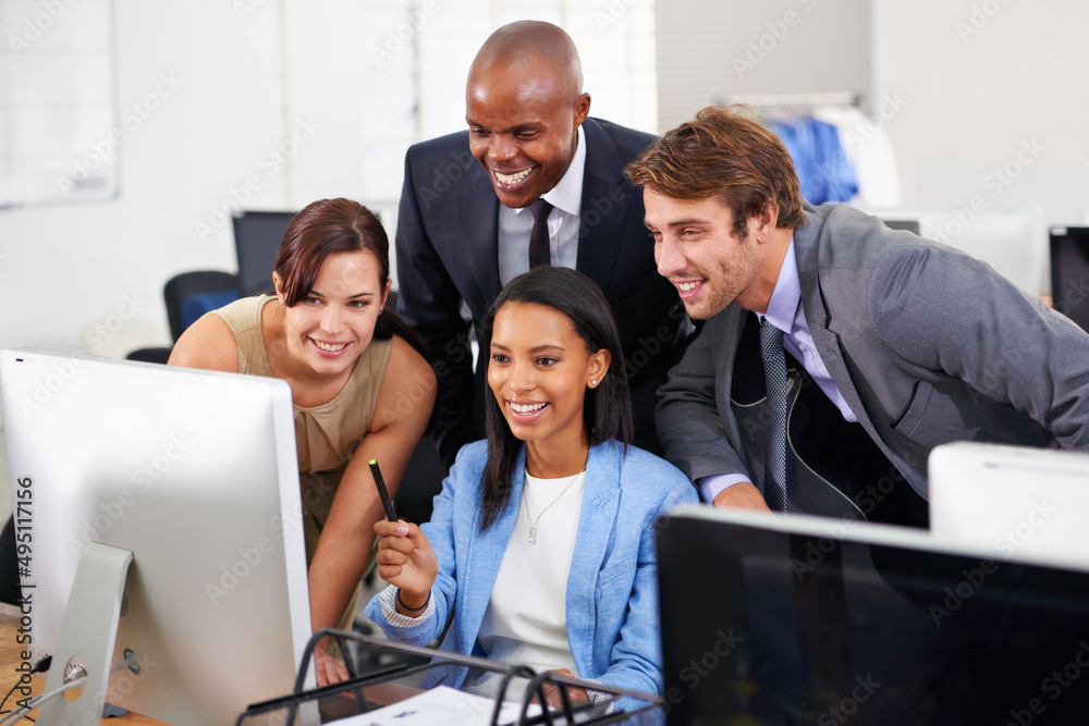 Poster they work well as a team. shot of a group of businesspeople working around a computer.