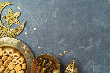 Flat lay composition for Ramadan kareem holiday with dried dates, Ramadan sweets and decorations. Top view background