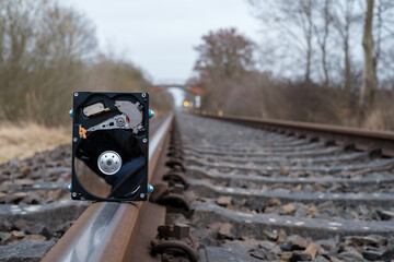  hard disk stands on the rails of the railroad