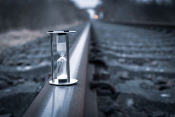 hourglass stands on the rails of the railroad