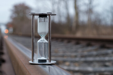 hourglass stands on the rails of the railroad