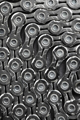 The texture of a bicycle chain is a close-up of the torque transmission links