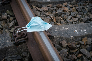 Obraz premium medical face mask lies on the railroad tracks