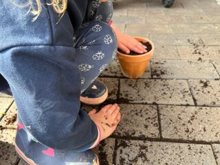 Kind bepflanzt Blumentopf