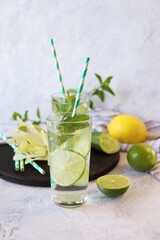 Detox water from citrus, mint leaves and cucumber slices in glasses, on a light background, healthy drinks, water for weight loss