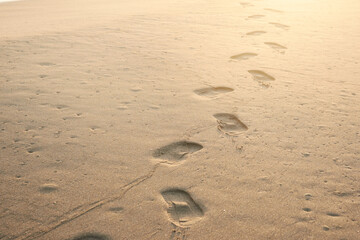 Fototapeta na wymiar Footprints in sand, inspirational and motivational concept image. can be used to represent peace freedom and summer vacation tourism