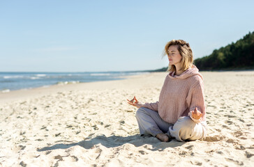 Fototapeta na wymiar Practicing yoga and relaxing time on empty beach