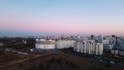 Obraz premium City block. Modern multi-storey buildings. Flying at dusk at sunset. Aerial photography.