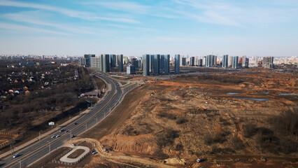 Construction of a modern city block Multi-storey buildings made of glass and concrete. Photographed in cloudy weather. Aerial photography.