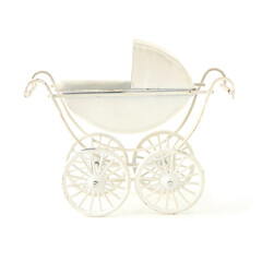 Fototapeta na wymiar Mini decorative baby stroller isolated on white background. Miniature decor retro baby carriage.