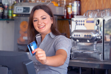 Bartender registrating new order by cash register. A restaurant worker registrating new order by...
