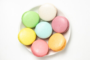 Fototapeta na wymiar Colored macarons on a white background. Light and tasty dessert. traditional dessert