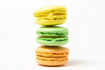 Colored macarons on a white background. Light and tasty dessert. traditional dessert