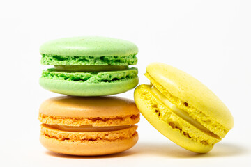 Colored macarons on a white background. Light and tasty dessert. traditional dessert