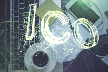 Blockchain theme hologram drawings over computer on the desktop background. Top view. Multi...