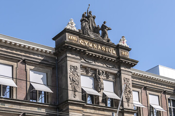 Architectural fragments of Barlaeus Gymnasium (established in 1884 - 1885) building in neo-classicism and eclecticism style. Amsterdam, the Netherlands.