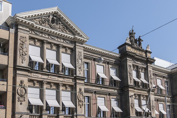 Architectural fragments of old Amsterdam building: Neo-classicism and eclecticism style Barlaeus Gymnasium (1885). Amsterdam, the Netherlands.