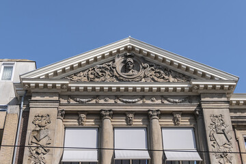 Fototapeta premium Architectural fragments of Barlaeus Gymnasium (established in 1884 - 1885) building in neo-classicism and eclecticism style. Amsterdam, the Netherlands.