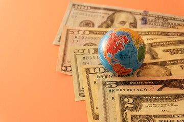 US banknotes and globe. Signs and symbols of global changes. The concept of currency in the world...
