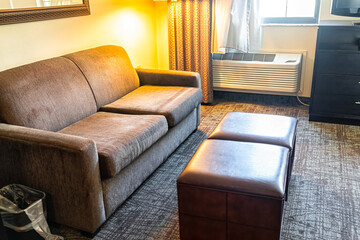 Hotel suite or studio room sofa couch lamp living room in modern hotel motel room with nobody no...