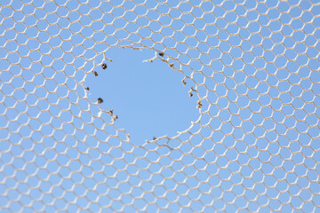 Burnt hole in insect netting. A hole in the whole, the concept of permeability. The weakest link, cell, the inconsistency of the net.