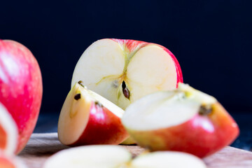 cutting old board with pieces of red ripe apple