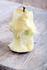 red ripe apple on a wooden chopping board