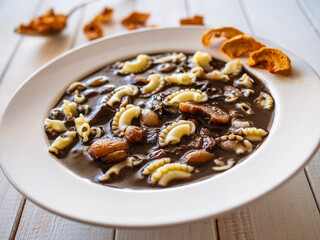 Fototapeta premium Blood soup with offal and sun dried fruits on wooden table