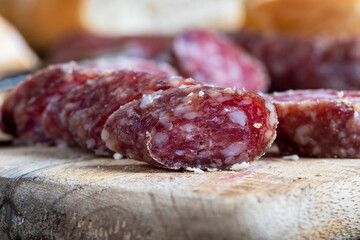 sliced pieces of sausage from meat are lying on a cutting board