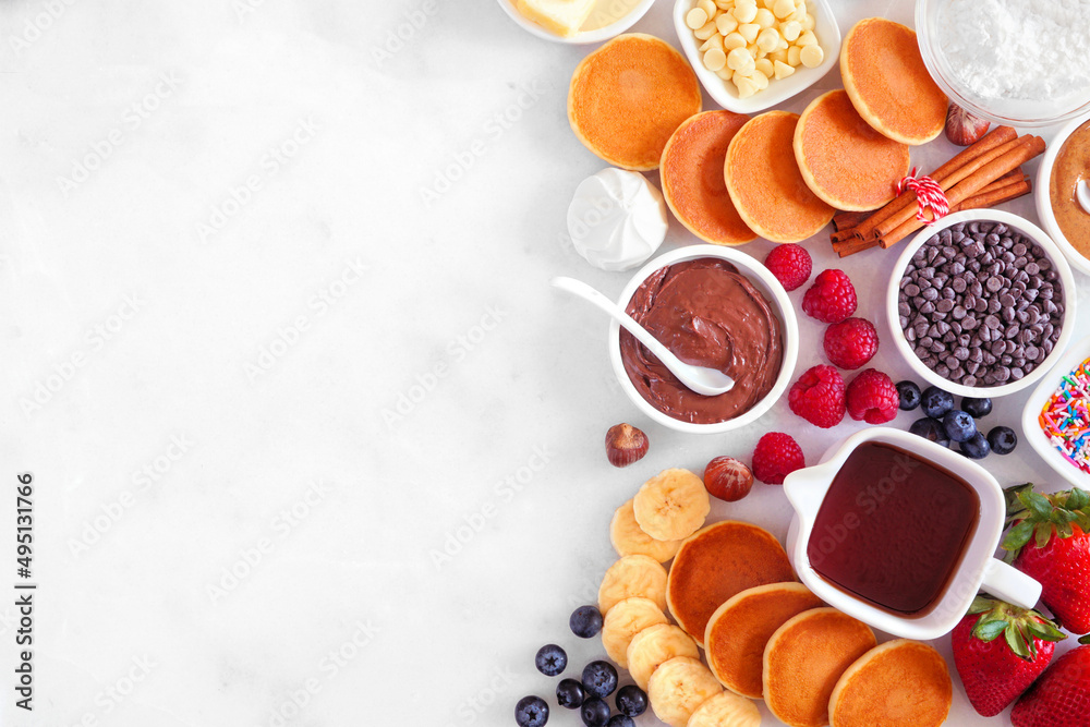 Poster breakfast or brunch pancake buffet side border. top view on a white marble background. mini pancakes