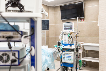 Patient monitor with vital signs in operating room with medical equipment