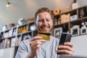 Positive caucasian man, entering his credit card pin on phone.
