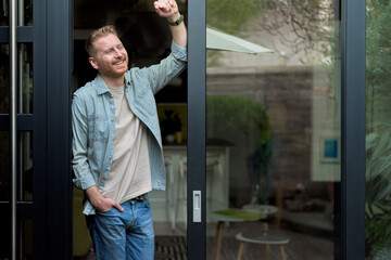 Portrait of tranquil caucasian man, relaxing, looking at his yard.