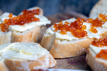 red salmon or trout caviar with white baguette and butter