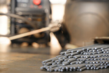 Welding electrodes extended from the bundle against the background of welding equipment