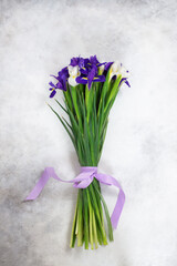 bouquet of lilac and white irises on a grey background. Horizontal view. Spring bouquet.