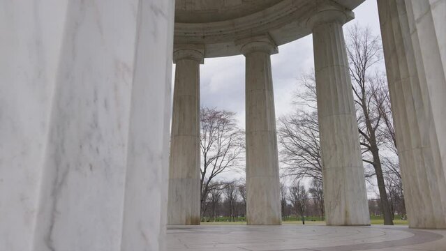 Interior shot of the columns of the  District of Columbia War Memorial, a memorial to DC residents who were killed in World War I, located on the National Mall in Washington, DC. Camera trucks right. 