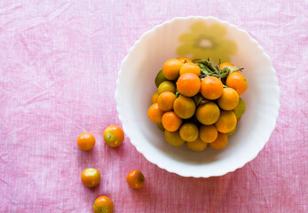 Bowl of healthy,fresh,juicy and sweet cape gooseberries,isolated on light background, Close up view of berries that are native to India and South America.