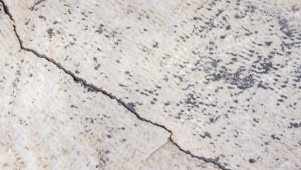 Cracked antique marble texture. Weather-cracked stone wall. Marble stone texture