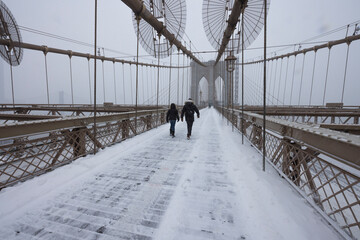 Snow wraps up the Brooklyn Bridge Promenade during winter snowstorm on January 29, 2022 at Lower Manhattan in New York City NY USA.