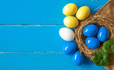 multi colors painted easter eggs in colors flag of ukraine yellow and blue. Happy Easter holiday card	
