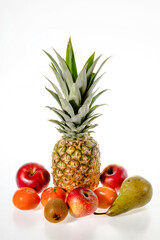 Beautiful view of pineapple, tangerines, apples, pear and kiwi isolated on white background. 