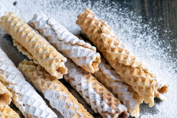 thin crispy waffles lie on a black table
