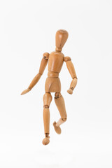 wooden doll in running position seen from the front