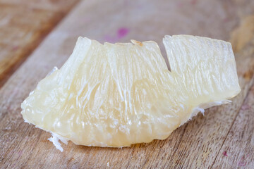 peeled slice of yellow citrus pomelo on the table