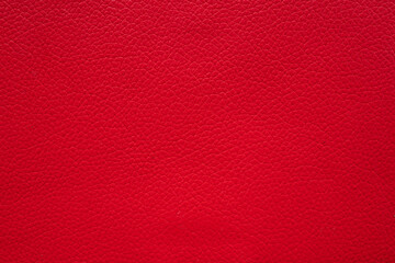 red faux leather background is used to wrap book covers or to repair everyday leather sofa seats and appliances. background and pattern on the red faux leather have space for text.