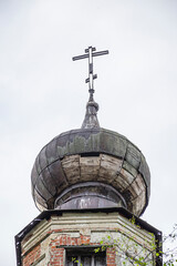 the dome of an abandoned church with a cross