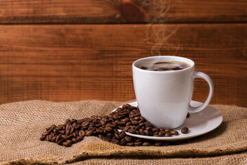 Coffee seeds with coffee cup - obrazy, fototapety, plakaty