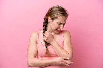 Young caucasian woman isolated on pink background with pain in elbow