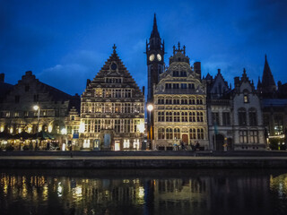 The historical city center of Ghent in Belgium in the evening reflected in a river